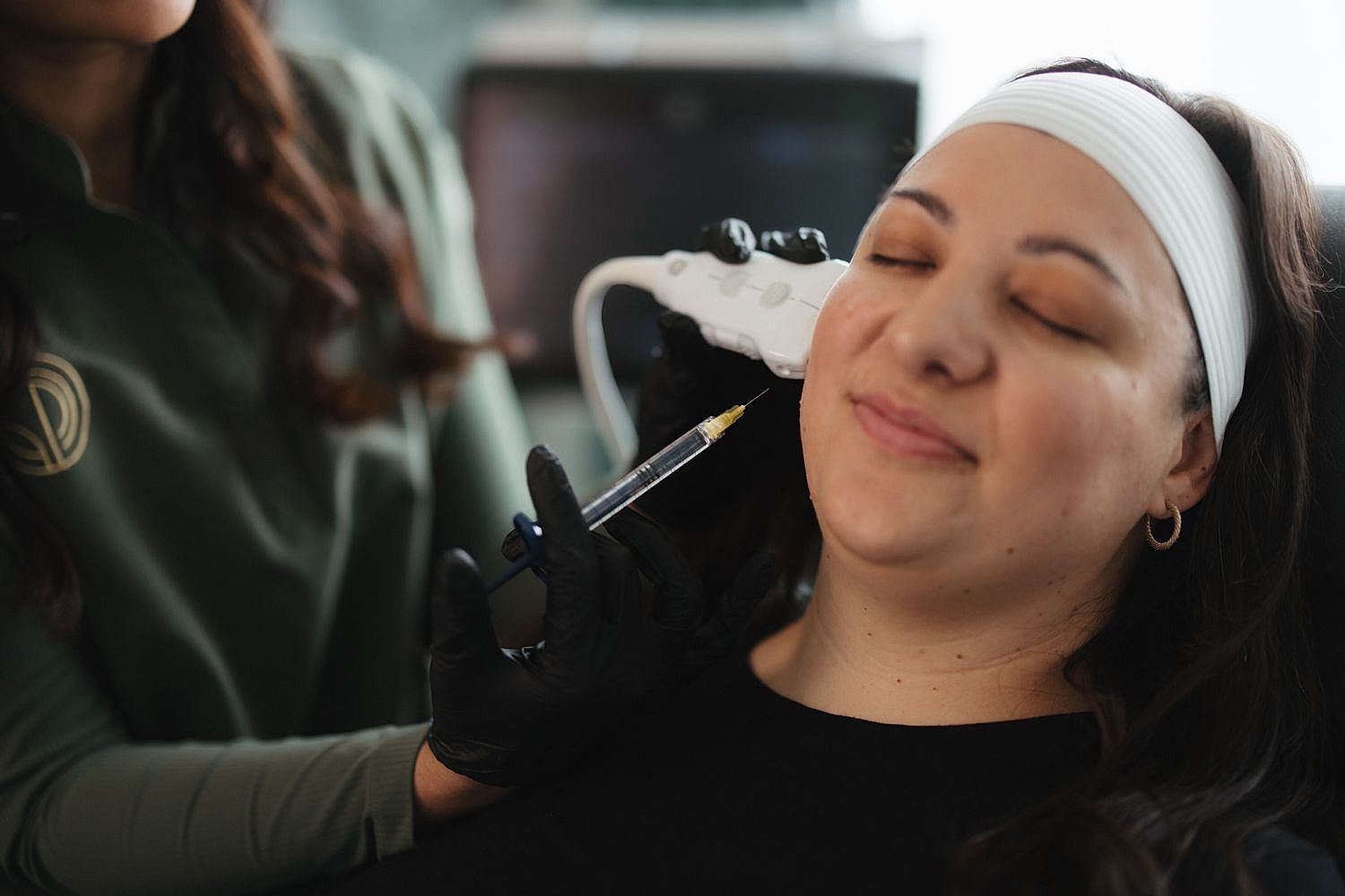 Woman receiving a cosmetic treatment at a clinic.
