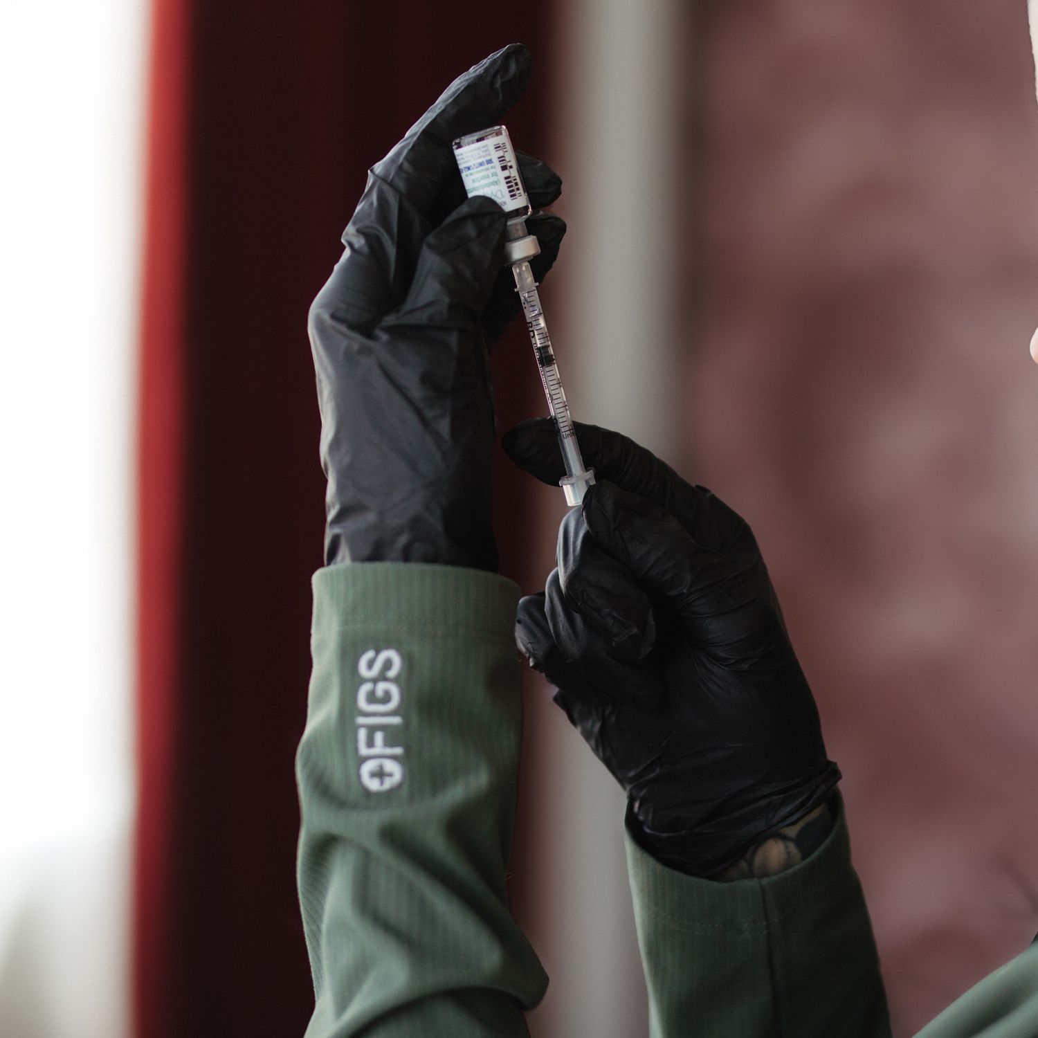 Close-up of a woman behind sheer fabric.