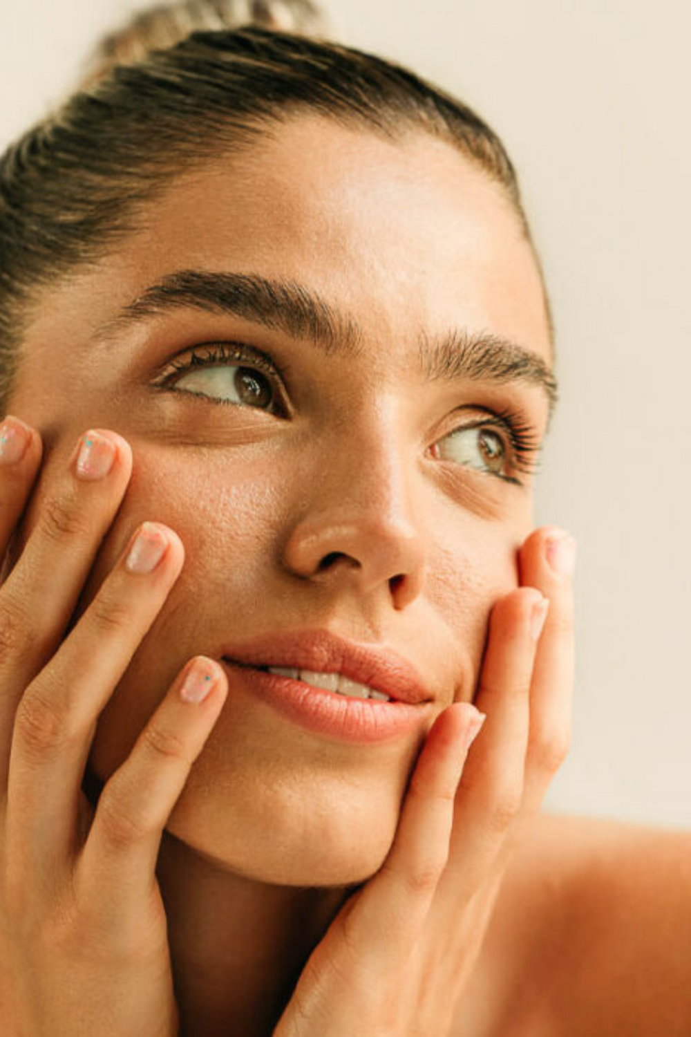 Smiling man touching his face, natural light.