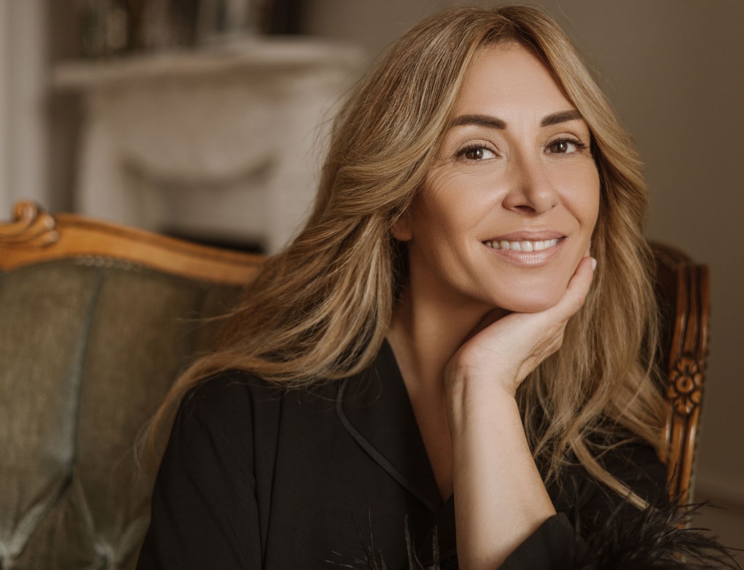 Smiling woman with blonde hair and clear skin.