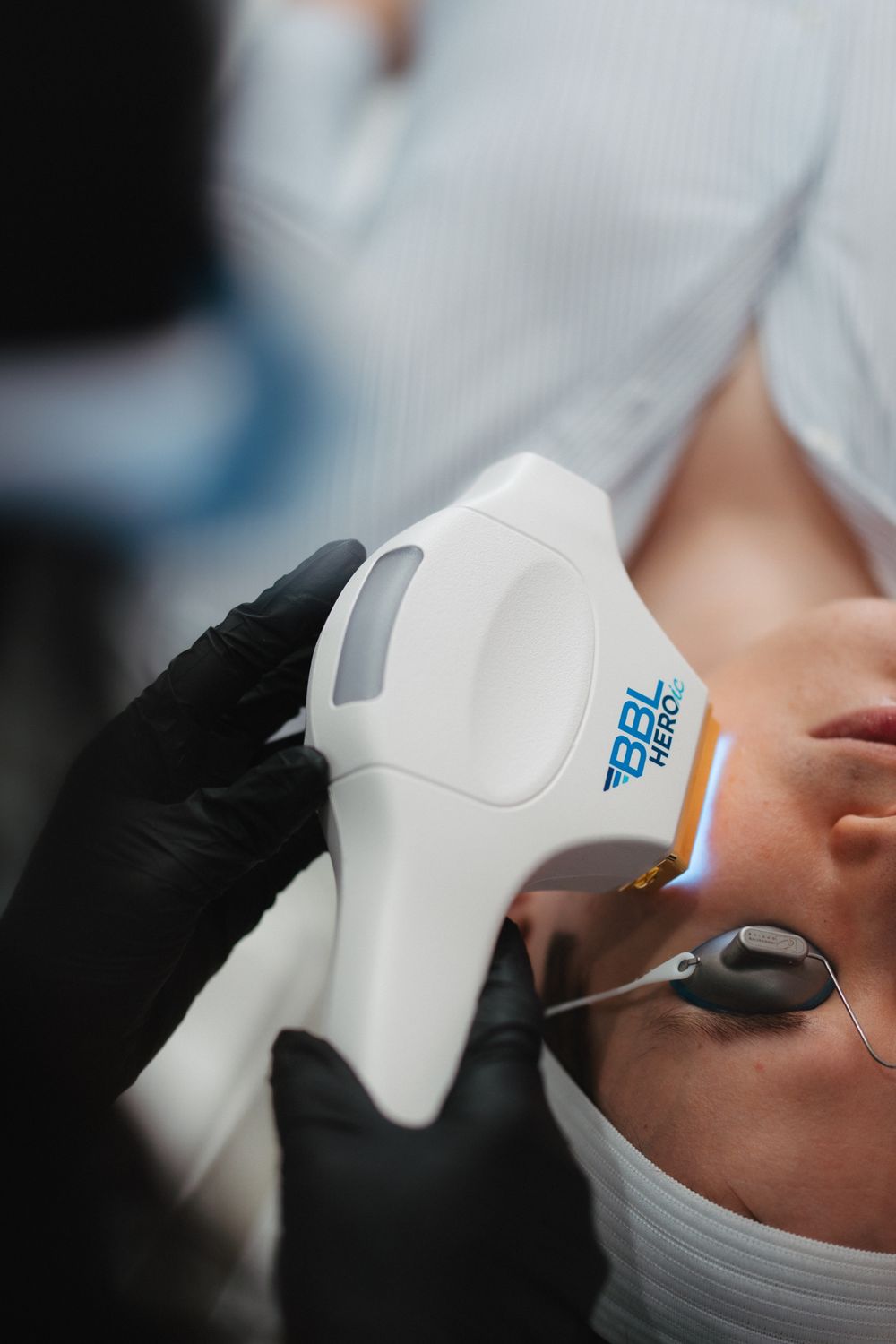 Young woman touching her face with a serene expression.
