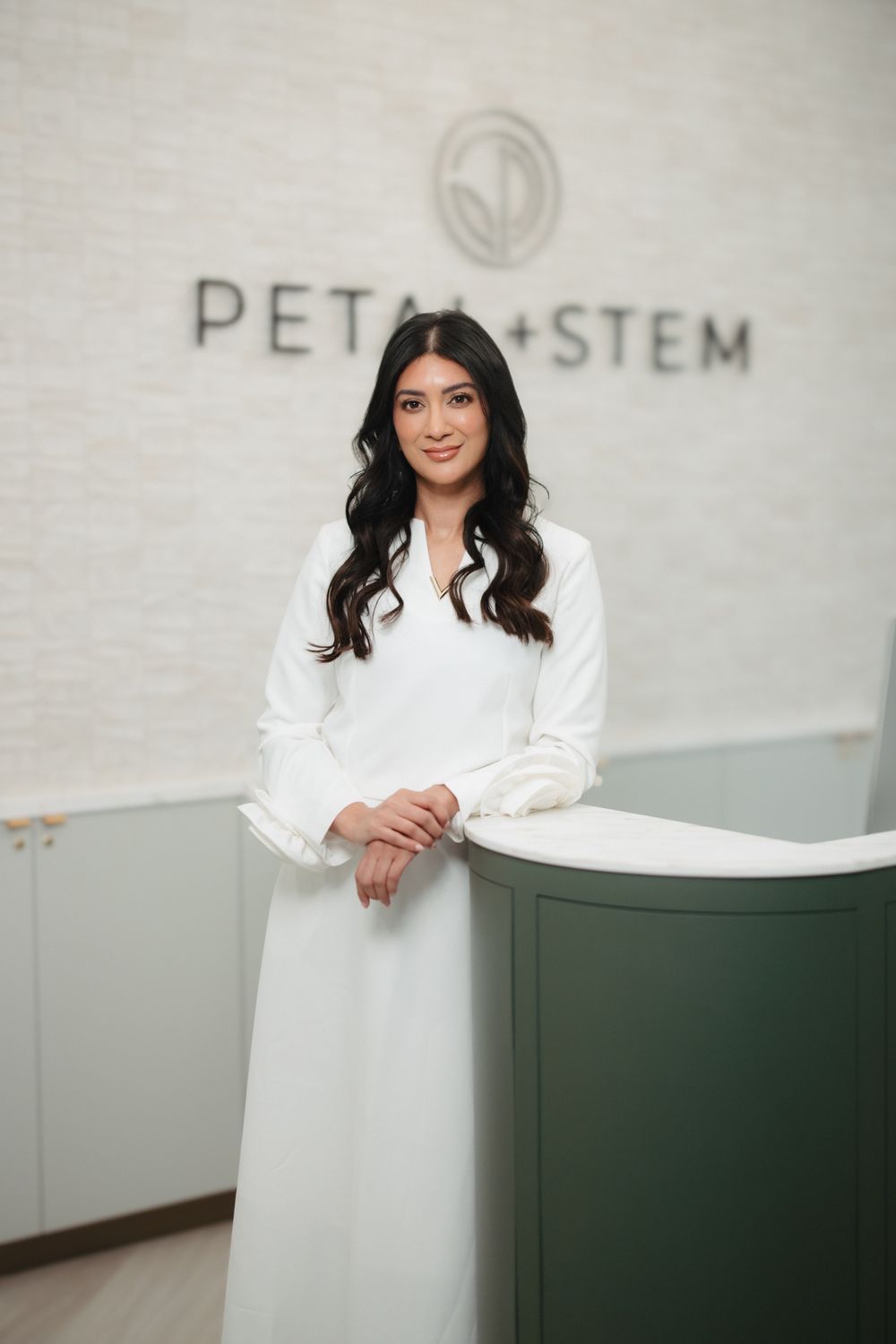 Woman in beige hijab with elegant accessories.