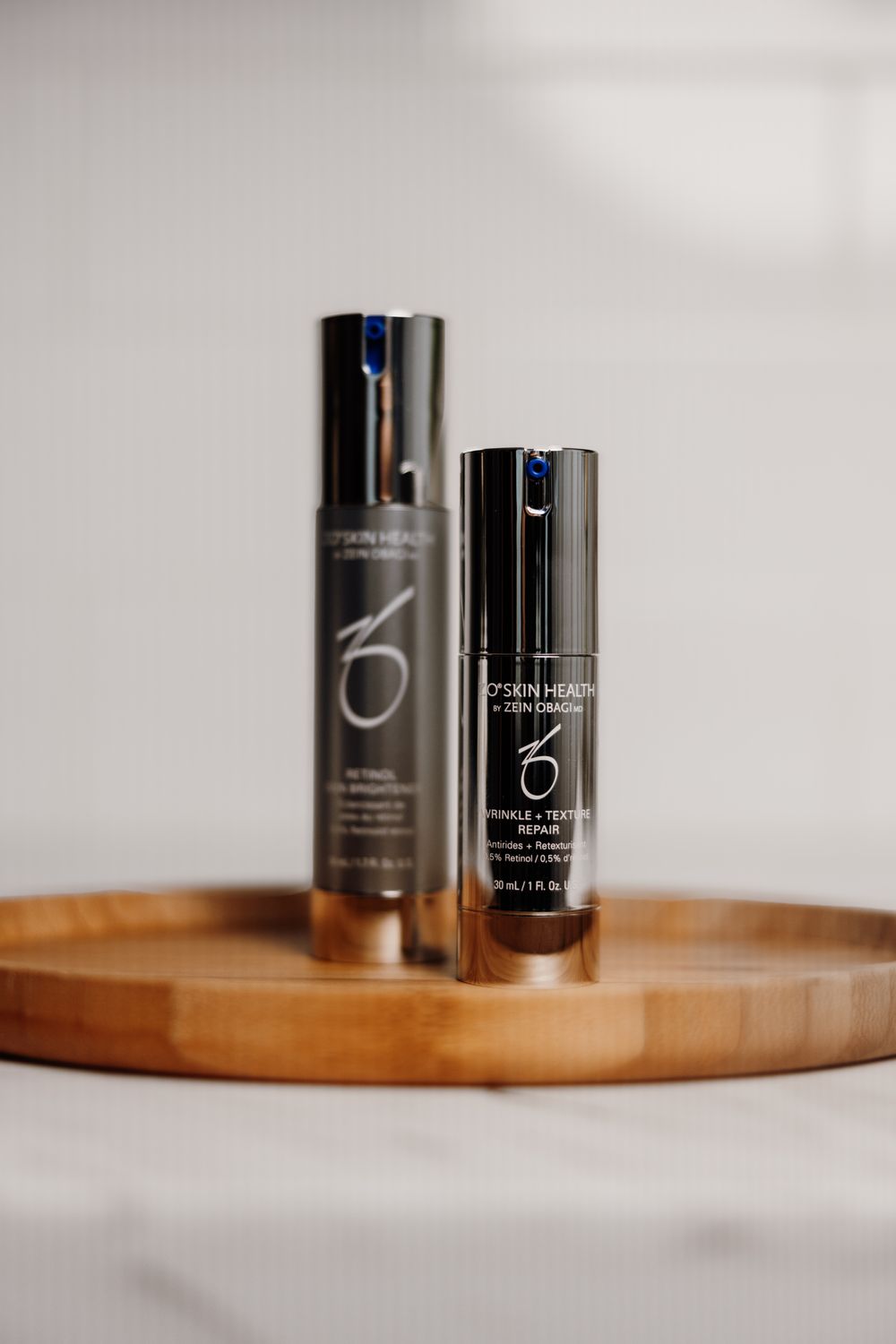 Skin care products on wooden tray.