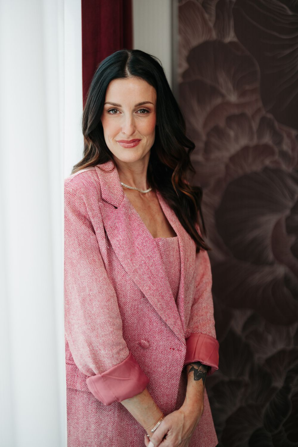 Woman with flowing hair in black outfit.