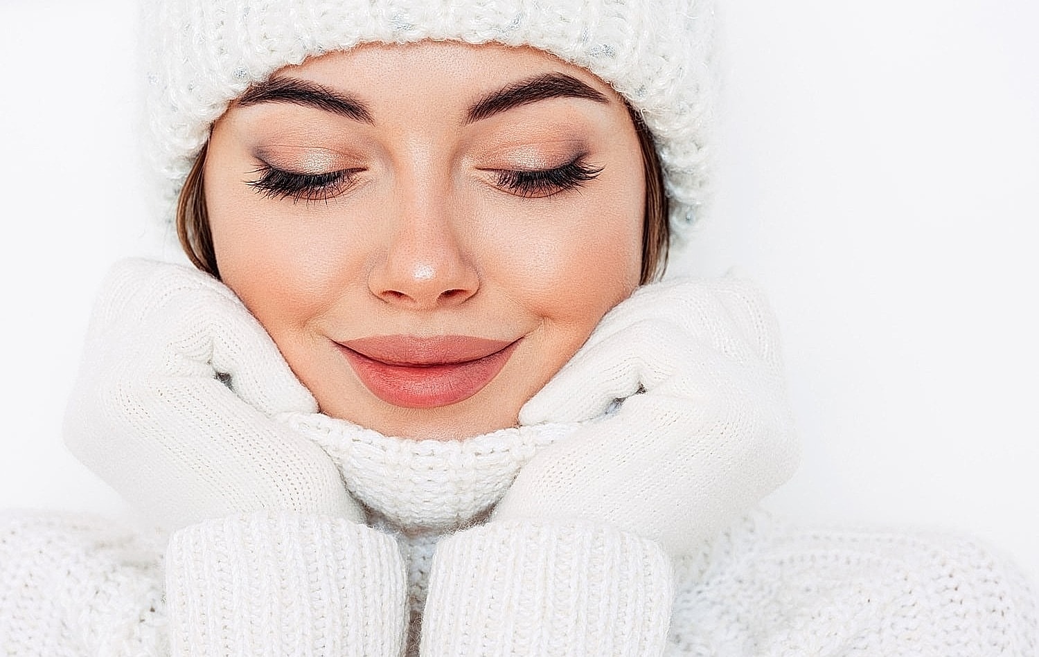 Woman smiling in cozy winter attire.