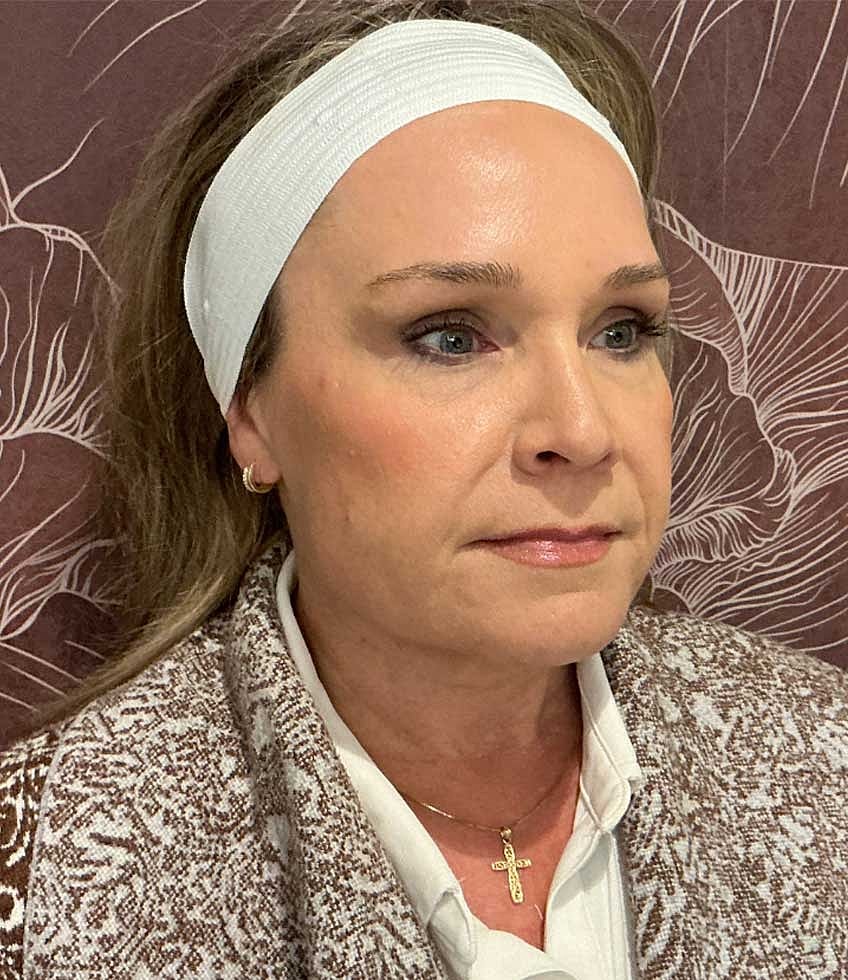 Woman with headband and patterned shawl.