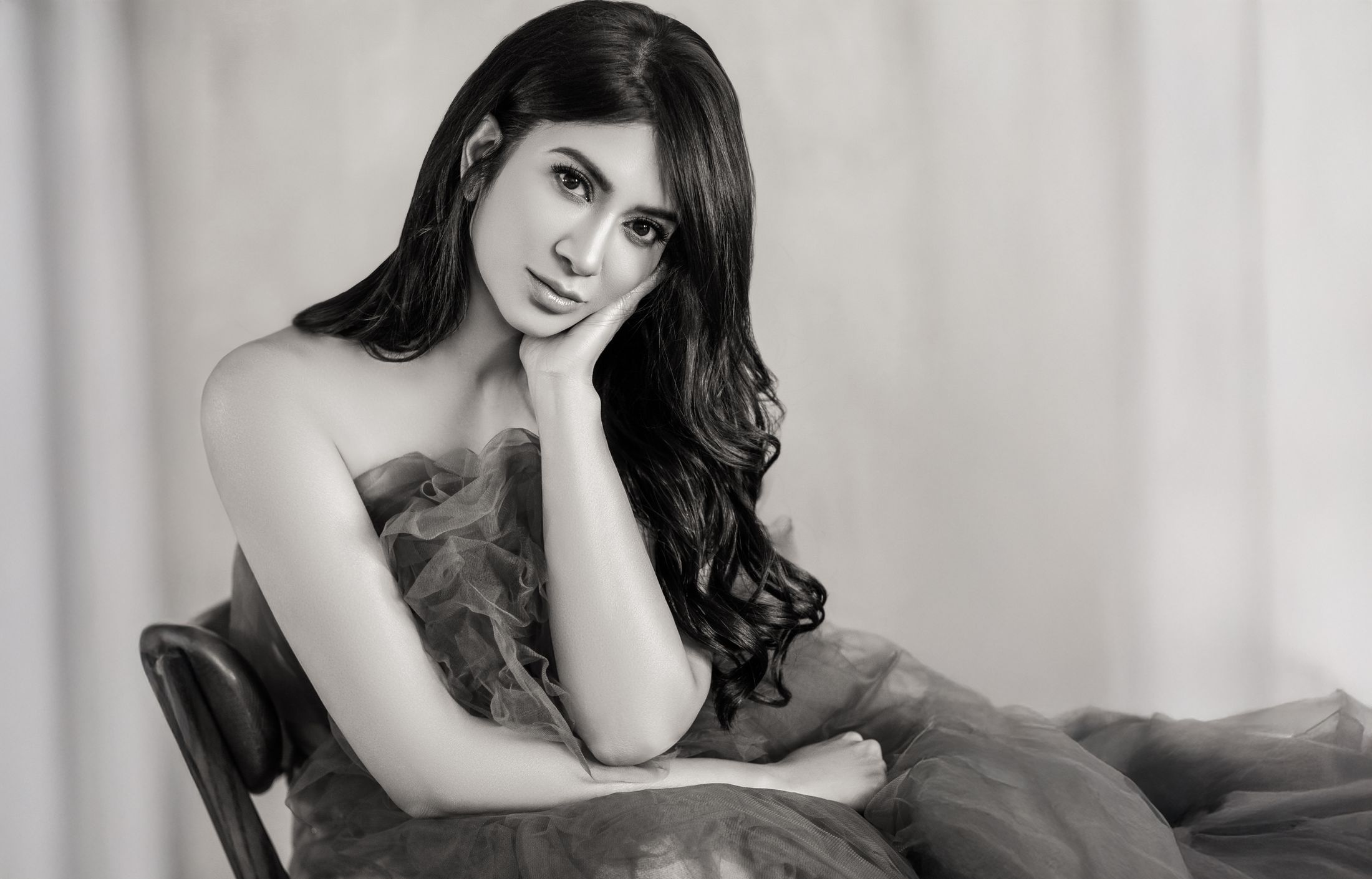 Woman in elegant pose, wearing a textured dress