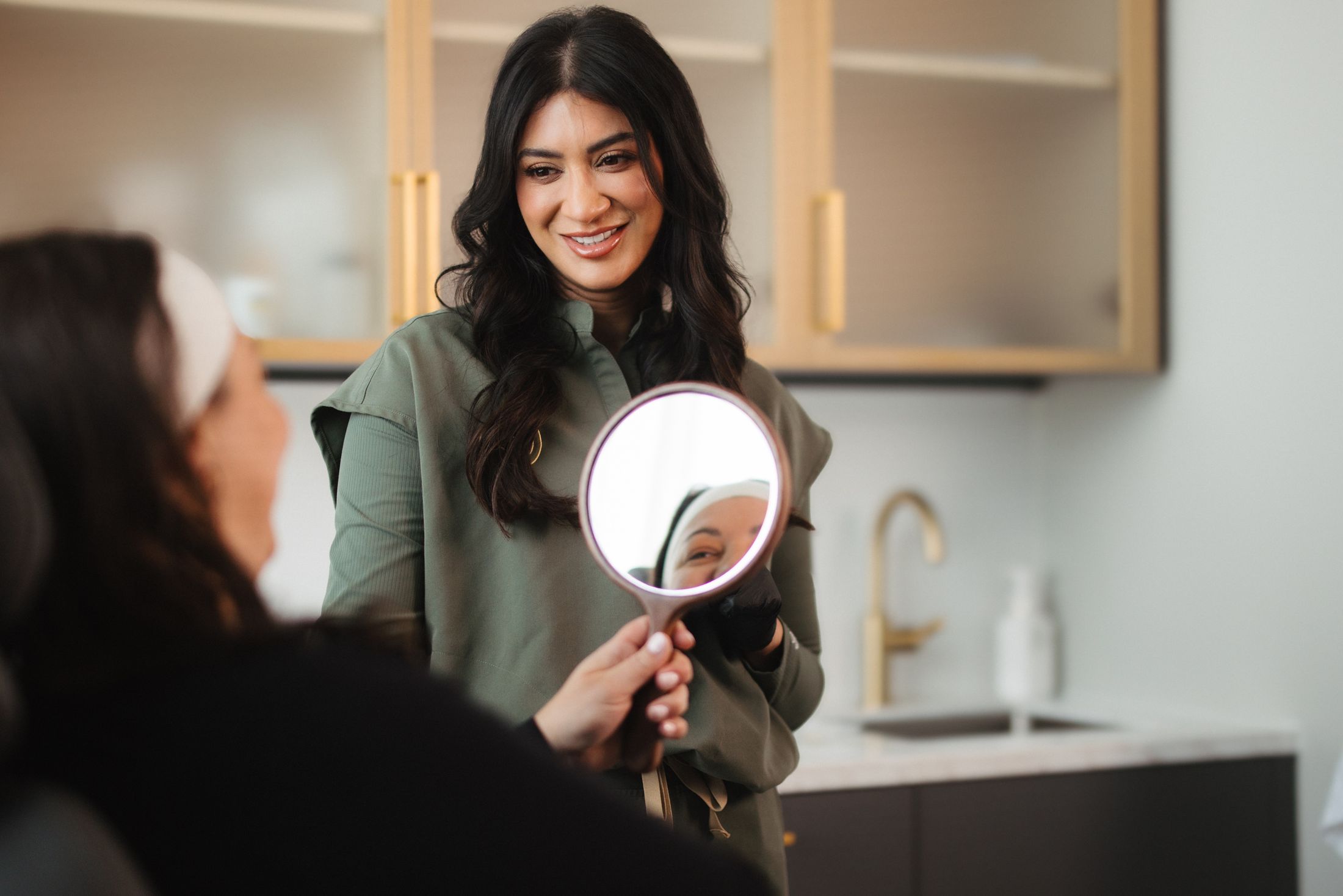 Skincare consultation with mirror reflection.