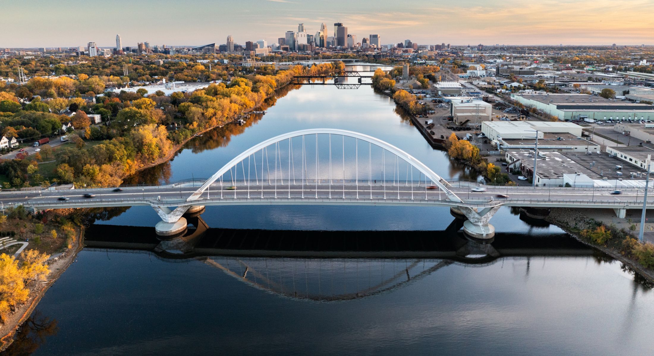Aerial view of bridge over autumn river.
