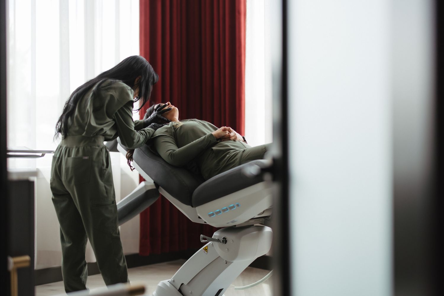 Woman posing gracefully in a dark setting.