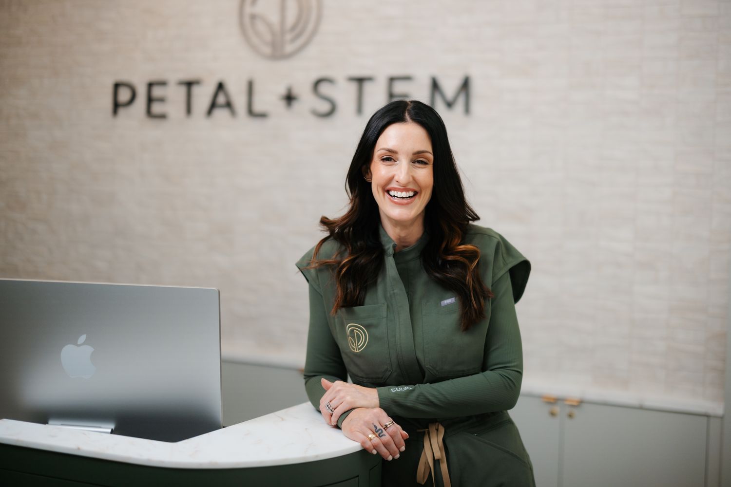 Smiling man in blue shirt, outdoors in nature.