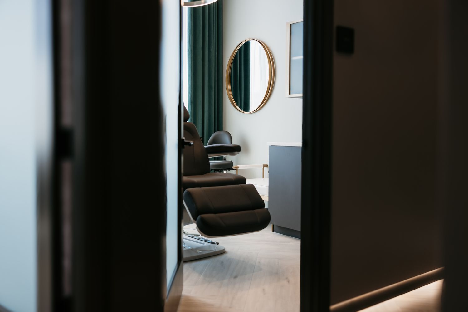 Smiling woman with curly hair, relaxed pose.