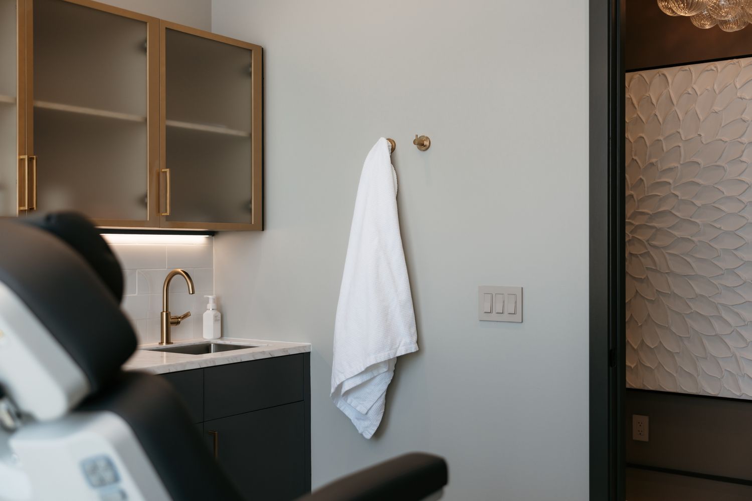 Smiling woman with short gray hair in blue.